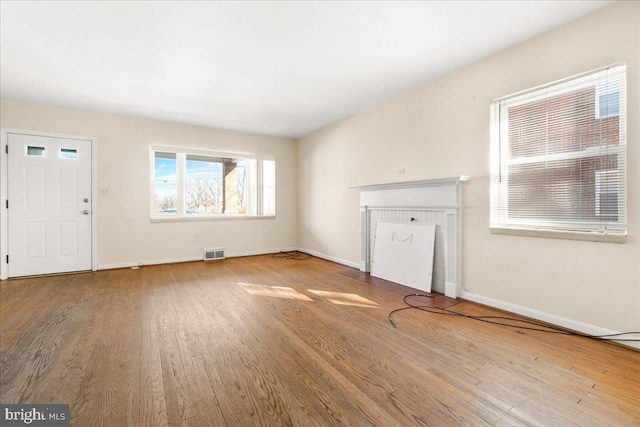 unfurnished living room featuring hardwood / wood-style floors