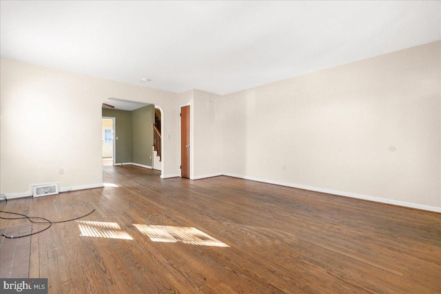 unfurnished room with dark hardwood / wood-style flooring