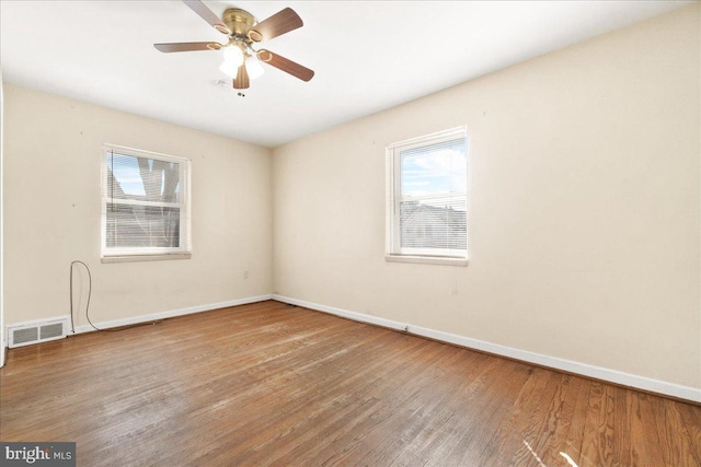 unfurnished room with ceiling fan and wood-type flooring