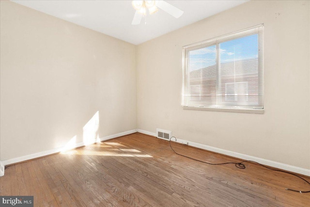 unfurnished room featuring hardwood / wood-style floors and ceiling fan