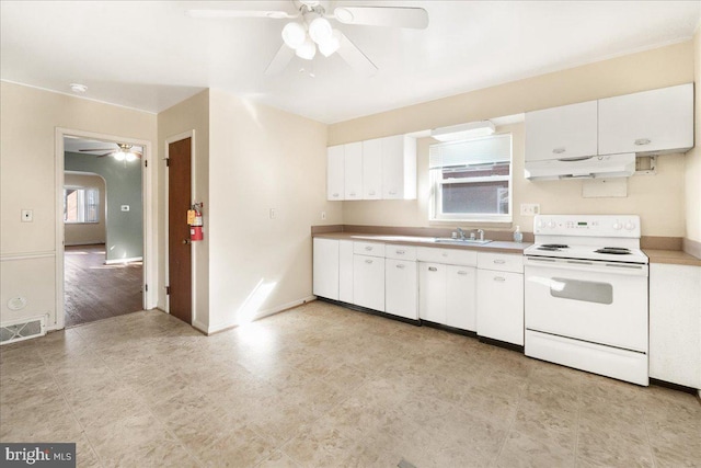 kitchen featuring ceiling fan, white cabinets, a wealth of natural light, and white range with electric stovetop