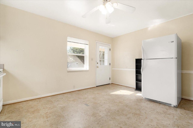 kitchen with ceiling fan and white fridge