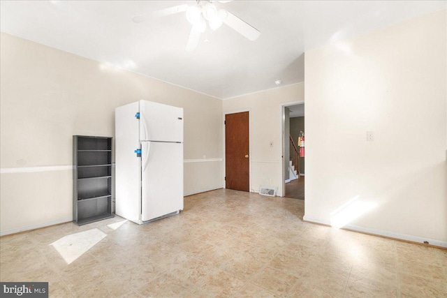 interior space with ceiling fan