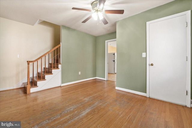 empty room with ceiling fan and wood-type flooring