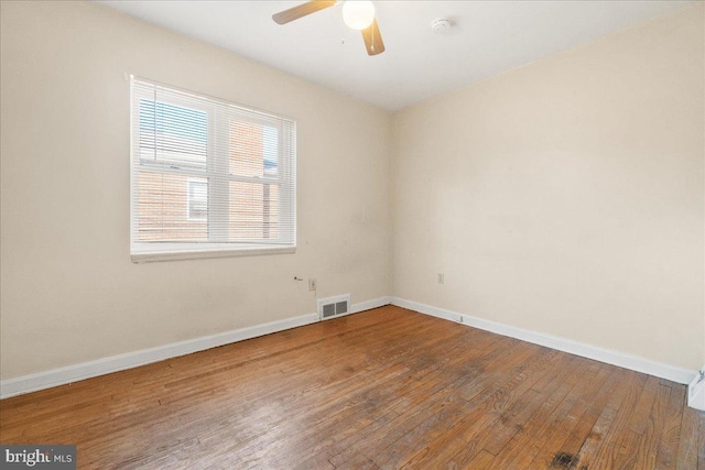 spare room featuring hardwood / wood-style flooring and ceiling fan