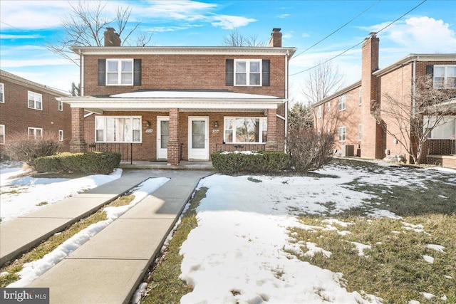 view of front of house with a porch and central AC unit