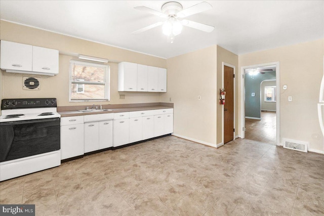 kitchen featuring white cabinetry, ceiling fan, sink, and white range with electric stovetop