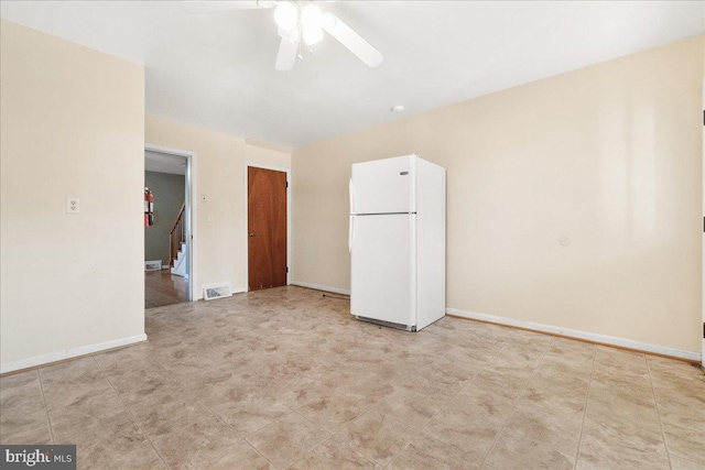 unfurnished bedroom featuring a closet, ceiling fan, and white refrigerator