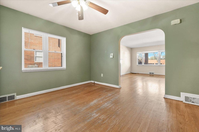 empty room featuring ceiling fan and light hardwood / wood-style flooring