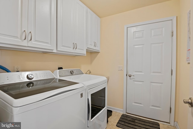 laundry room with baseboards, cabinet space, independent washer and dryer, and light tile patterned flooring