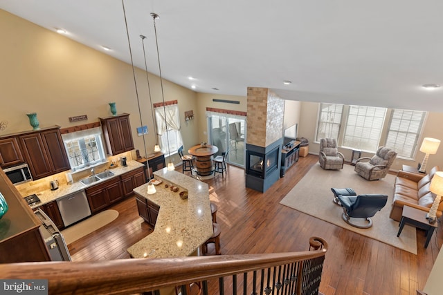 living room with hardwood / wood-style flooring and vaulted ceiling