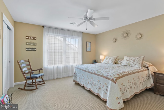 bedroom with carpet, visible vents, baseboards, ceiling fan, and a closet