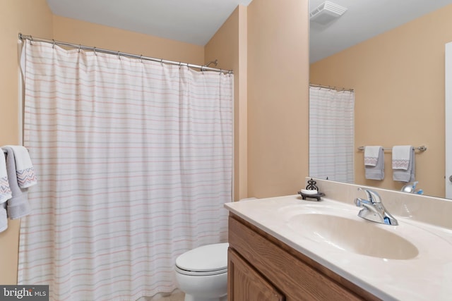 full bath featuring vanity, toilet, and visible vents