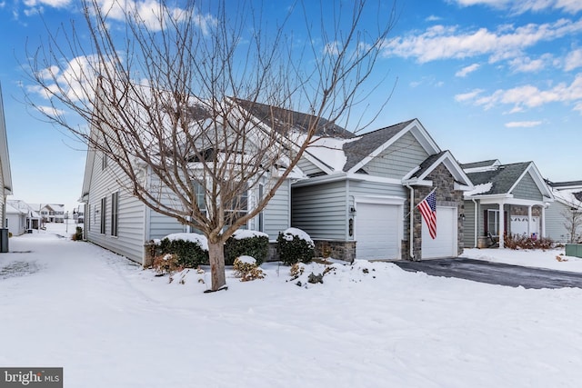 view of front of house featuring stone siding and an attached garage