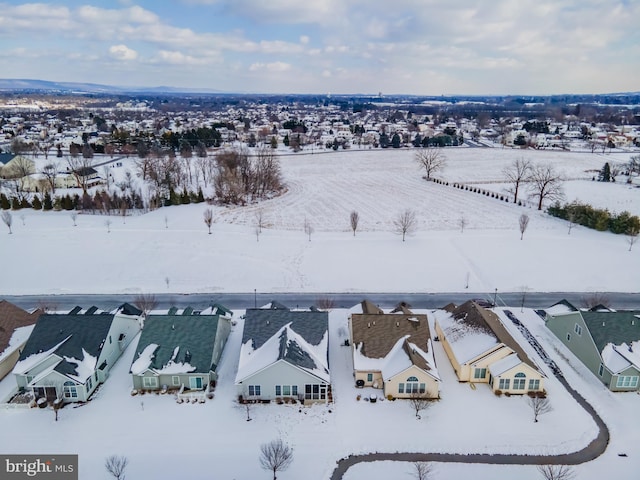 snowy aerial view featuring a residential view