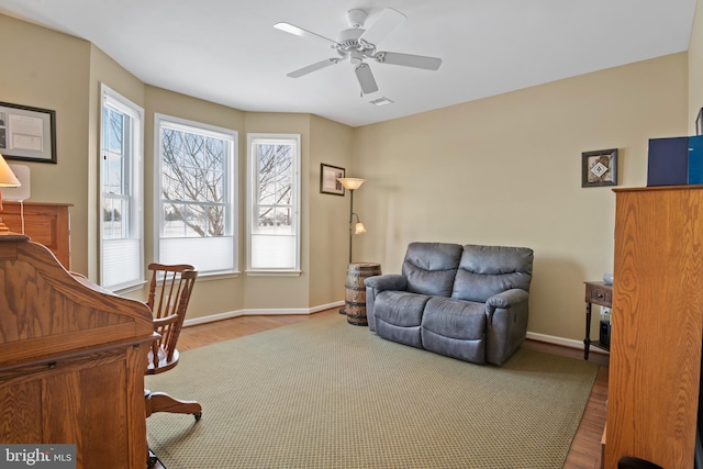 office area with visible vents, wood finished floors, baseboards, and ceiling fan