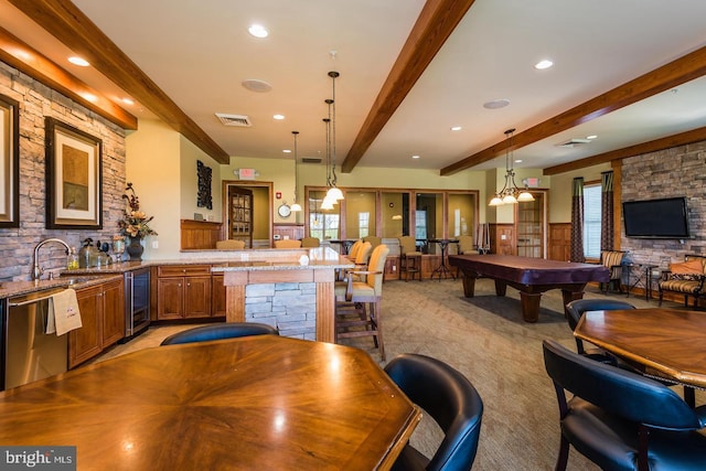 kitchen featuring beverage cooler, visible vents, a sink, stainless steel dishwasher, and beamed ceiling