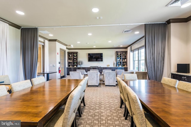 dining area featuring visible vents and ornamental molding