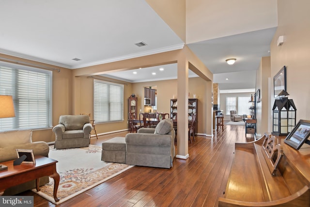 living room featuring visible vents, ornamental molding, baseboards, and dark wood-style flooring