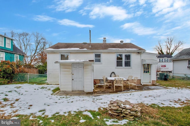 view of snow covered back of property