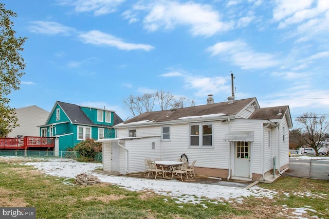 back of house featuring a yard and a storage unit