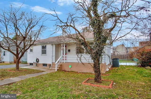 view of front of property featuring central AC unit and a front lawn