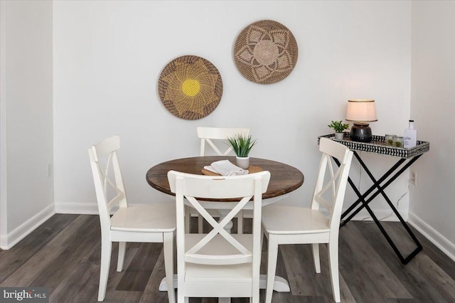 dining space featuring dark hardwood / wood-style floors