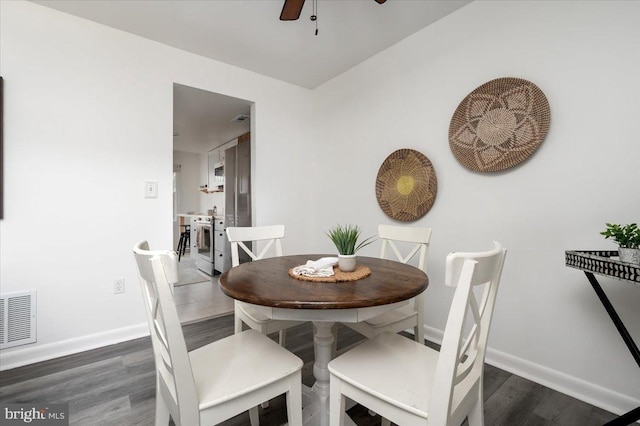 dining area featuring ceiling fan and dark hardwood / wood-style flooring