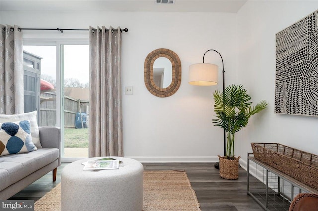 sitting room featuring plenty of natural light and dark hardwood / wood-style floors