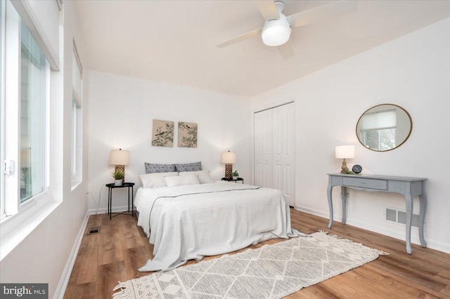 bedroom with ceiling fan, hardwood / wood-style floors, and a closet