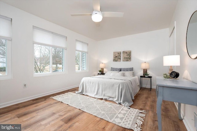 bedroom with hardwood / wood-style floors and ceiling fan