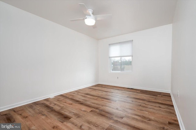 unfurnished room with hardwood / wood-style flooring and ceiling fan