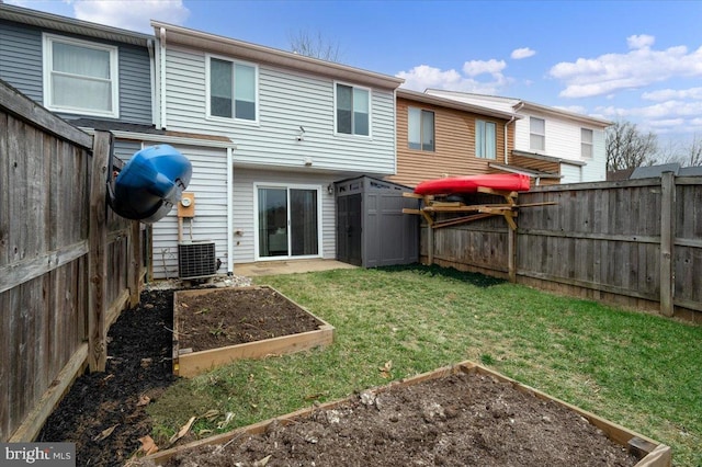 back of house with a yard, central AC unit, and a shed