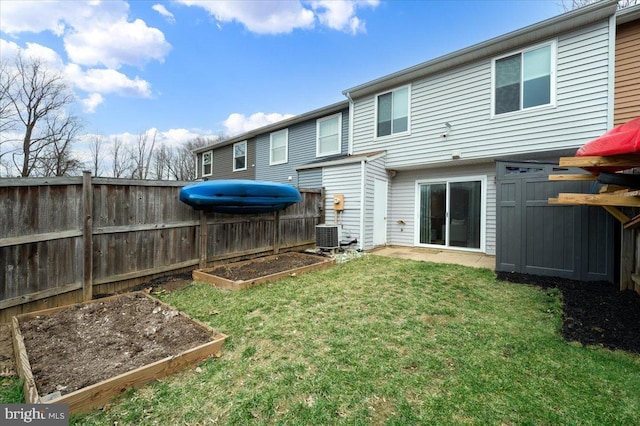 back of property featuring central AC unit and a lawn