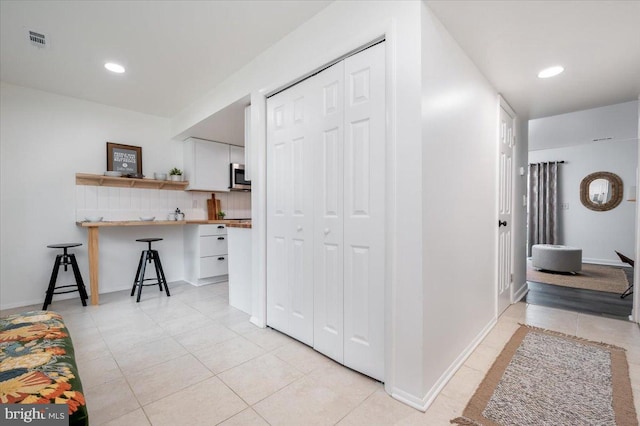 hallway with light tile patterned flooring