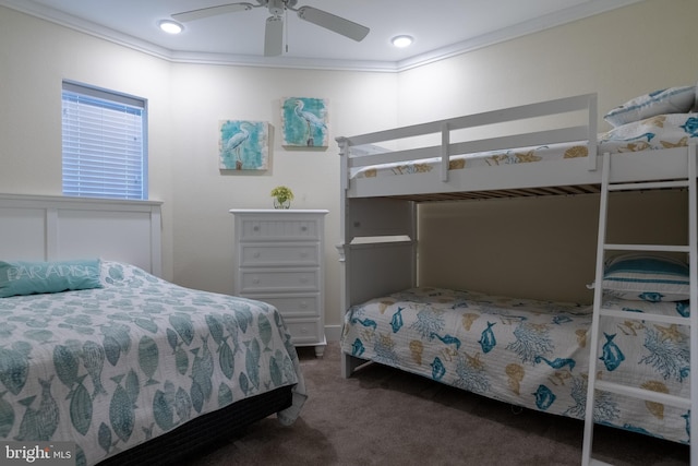 bedroom with ornamental molding, dark carpet, and ceiling fan