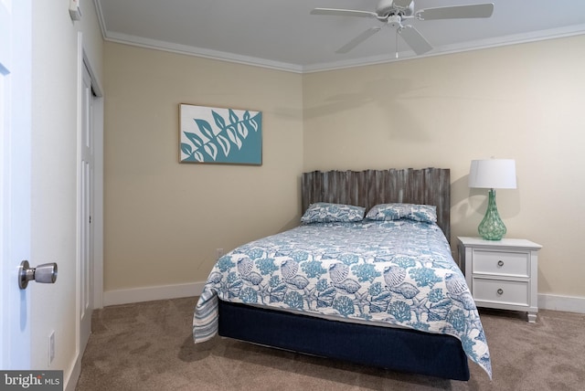 carpeted bedroom with ceiling fan and ornamental molding