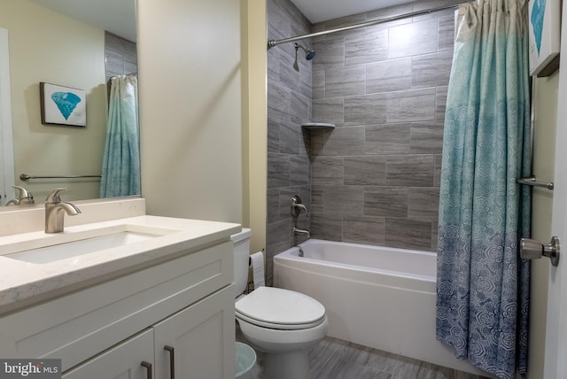 full bathroom with vanity, shower / tub combo, and toilet