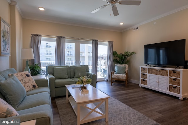 living room featuring crown molding, dark hardwood / wood-style floors, and a healthy amount of sunlight