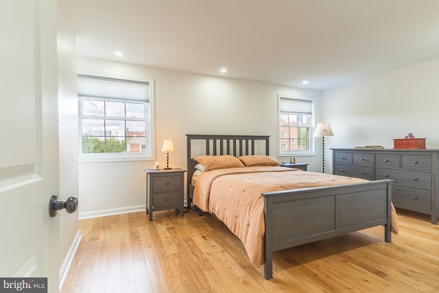 bedroom featuring multiple windows and light hardwood / wood-style floors