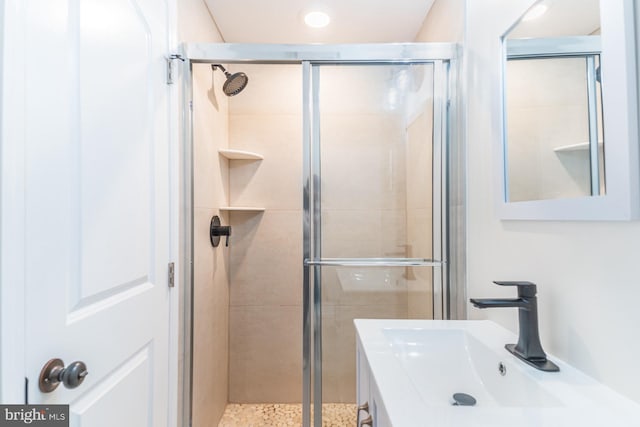 bathroom with sink and a shower with shower door