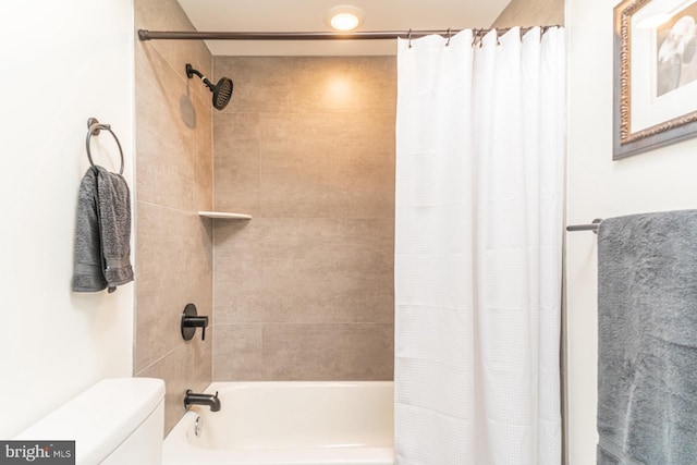 bathroom featuring shower / bath combo and toilet