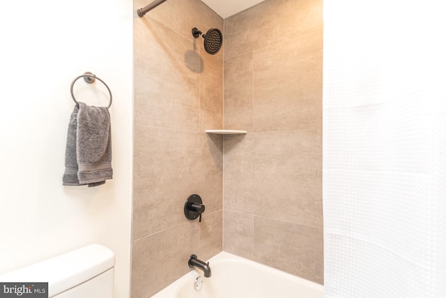 bathroom featuring shower / bathtub combination with curtain and toilet