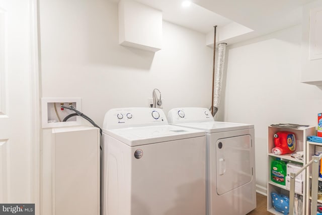 laundry room with wood-type flooring and washer and dryer