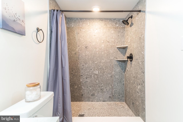 bathroom with toilet and curtained shower