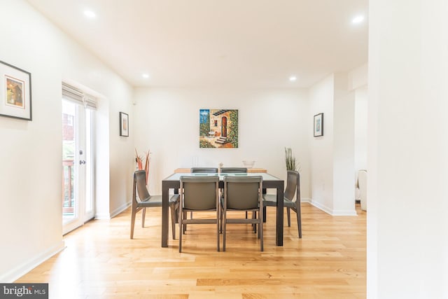 dining area with plenty of natural light and light hardwood / wood-style floors