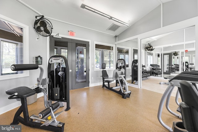 gym with high vaulted ceiling, french doors, and visible vents