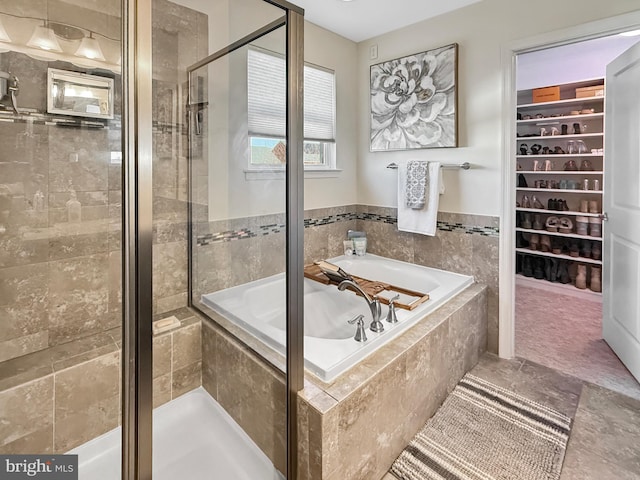 932 Still Pond Dr, Glen Burnie, MD 21060 - bathroom with a spacious closet, a bath, and a shower stall
