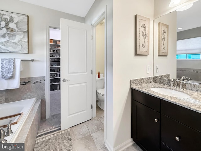 932 Still Pond Dr, Glen Burnie, MD 21060 - bathroom with a spacious closet, baseboards, toilet, a garden tub, and vanity