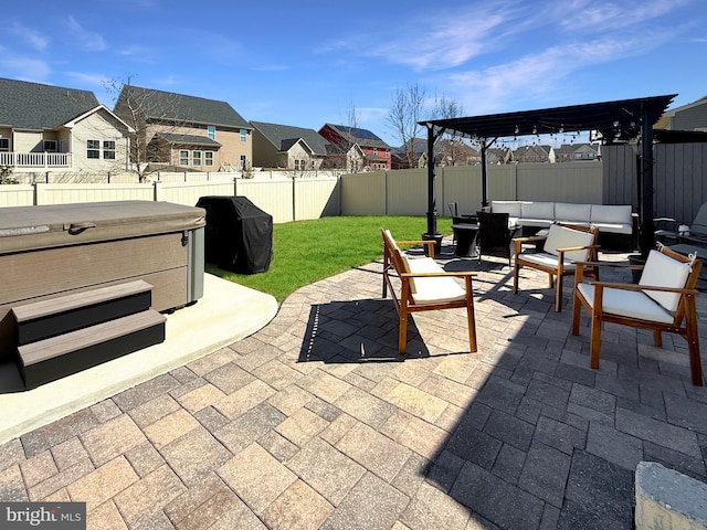 932 Still Pond Dr, Glen Burnie, MD 21060 - view of patio / terrace with a hot tub, a residential view, outdoor lounge area, a fenced backyard, and area for grilling